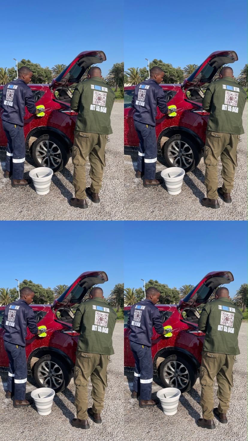 TSL Elite team member in branded uniform detailing a vehicle
